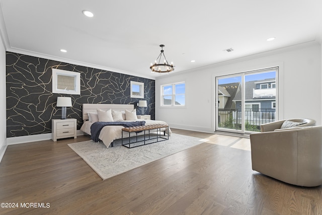 bedroom featuring ornamental molding, hardwood / wood-style flooring, access to outside, and a notable chandelier