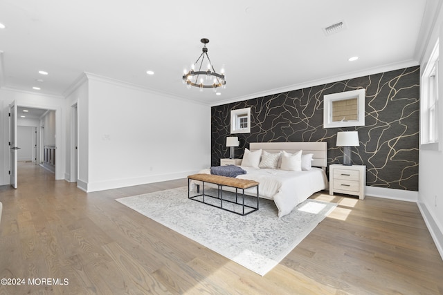 bedroom with a notable chandelier, ornamental molding, and hardwood / wood-style flooring