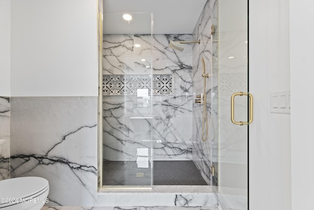 bathroom featuring toilet, tile walls, and a shower with shower door