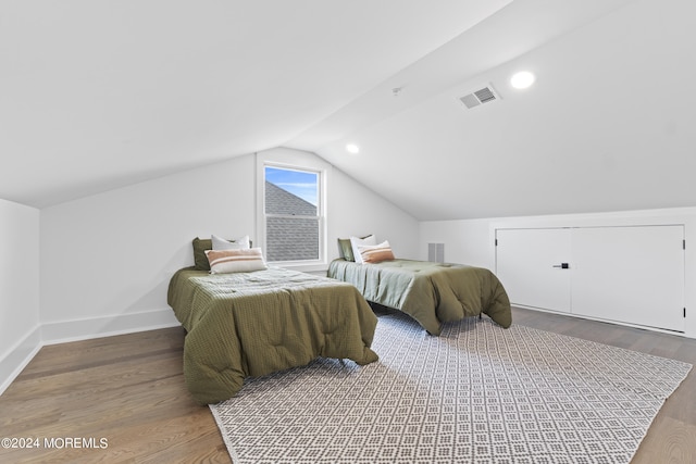 bedroom featuring hardwood / wood-style flooring and vaulted ceiling