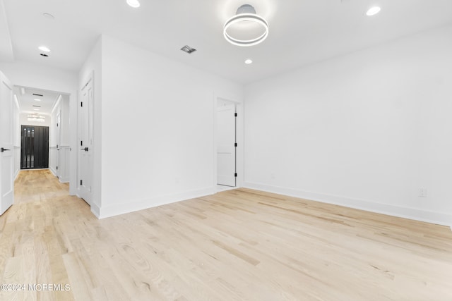 spare room with light hardwood / wood-style flooring