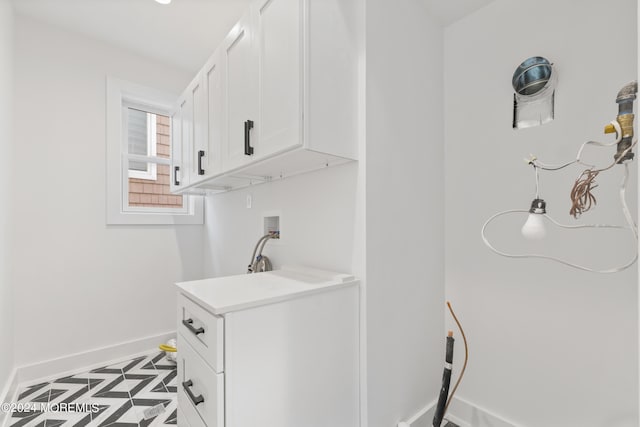 washroom featuring washer hookup and cabinets