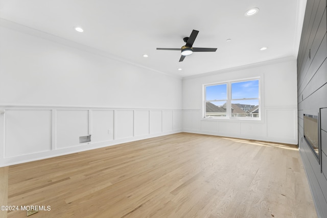 empty room with ceiling fan, light hardwood / wood-style flooring, and ornamental molding