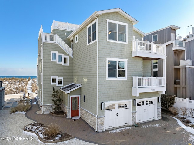 view of front of property featuring a garage and a balcony