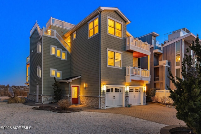 contemporary home featuring a garage and a balcony