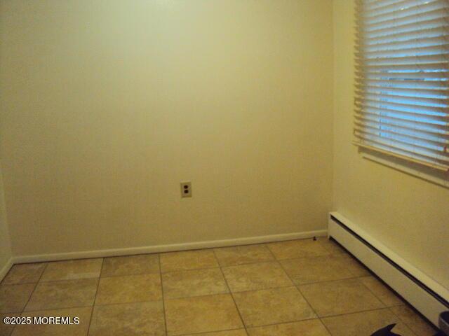 empty room featuring a baseboard radiator