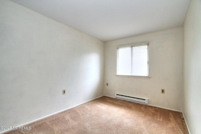 carpeted spare room with a baseboard radiator