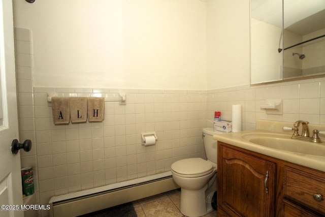 bathroom featuring tile walls, tile patterned floors, vanity, and a baseboard radiator