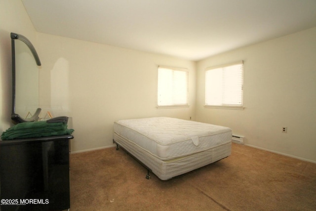 carpeted bedroom featuring a baseboard heating unit