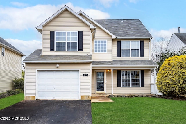 view of front facade featuring a front lawn and a garage