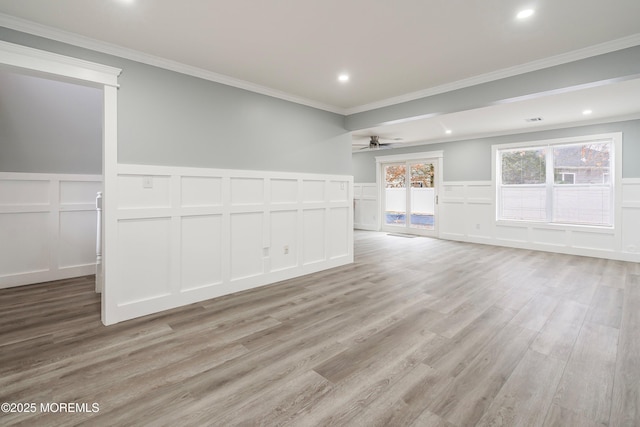 spare room with ceiling fan, light wood-type flooring, and ornamental molding