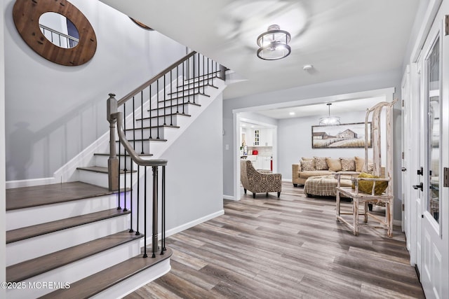 staircase with hardwood / wood-style floors