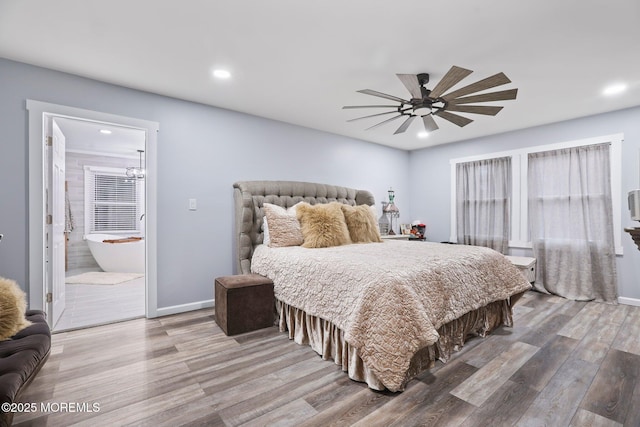 bedroom featuring ceiling fan, ensuite bathroom, and hardwood / wood-style floors