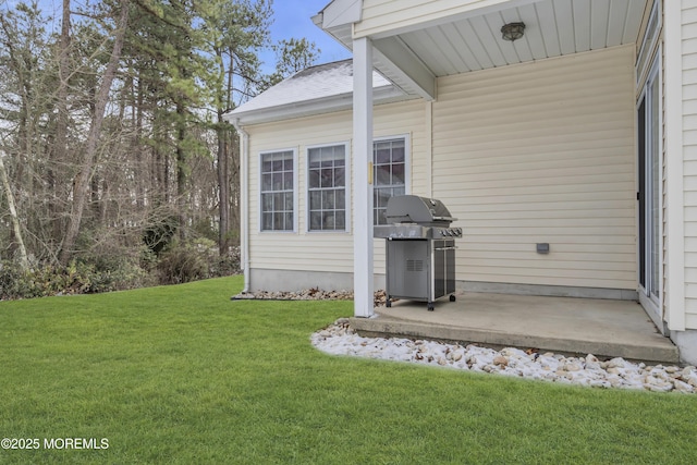 view of exterior entry with a yard