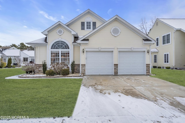 view of front of home featuring a garage and a front lawn