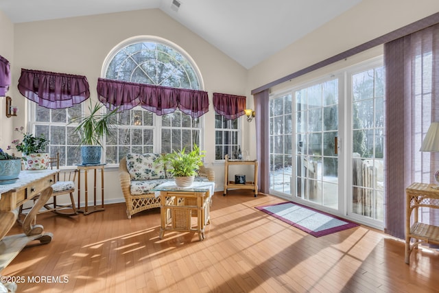 sunroom featuring lofted ceiling and a wealth of natural light