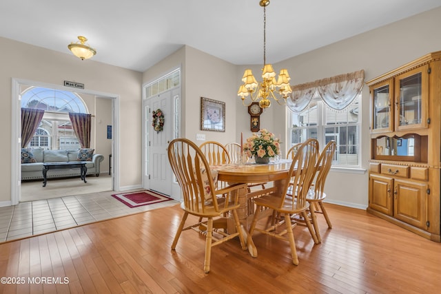 dining area featuring a notable chandelier and light hardwood / wood-style flooring