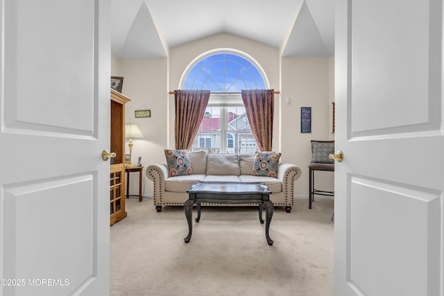 living area featuring vaulted ceiling and light carpet