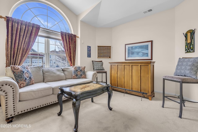 living area featuring vaulted ceiling and light carpet