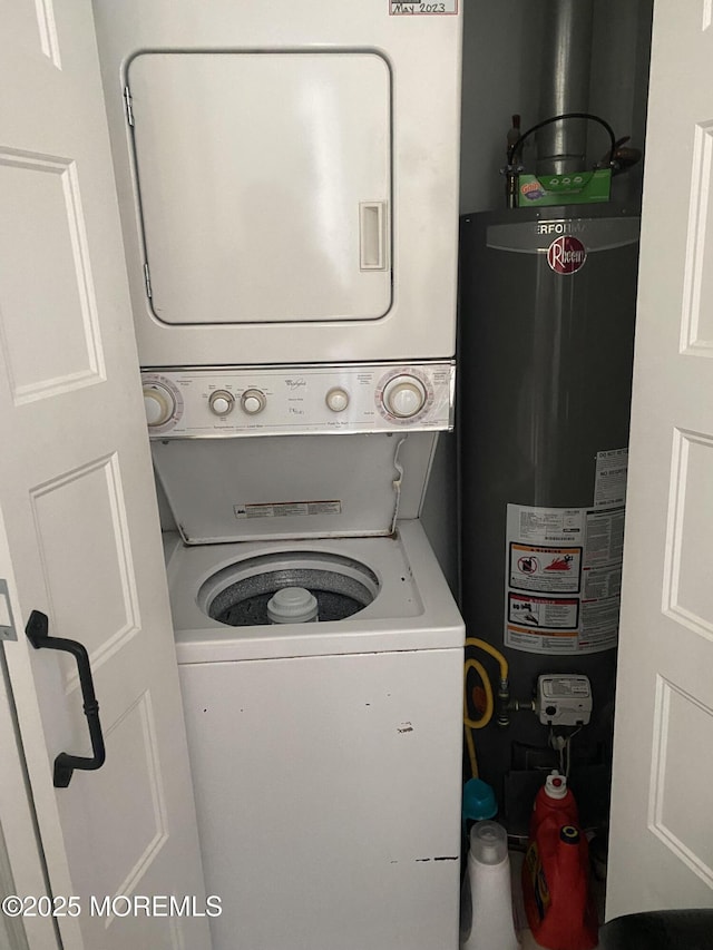 washroom featuring stacked washer and dryer and water heater