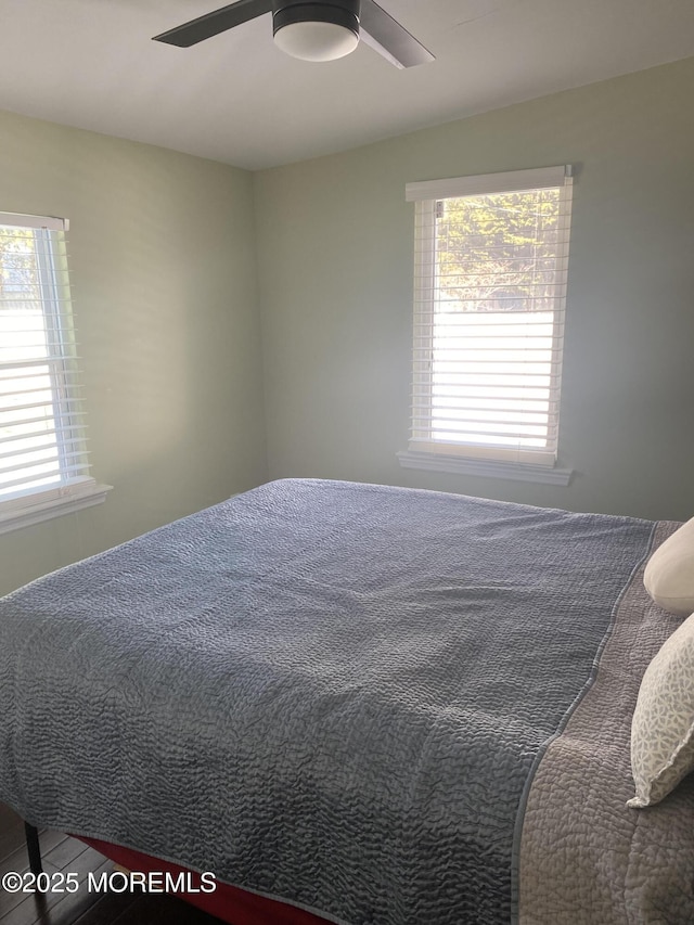 bedroom with wood-type flooring and ceiling fan