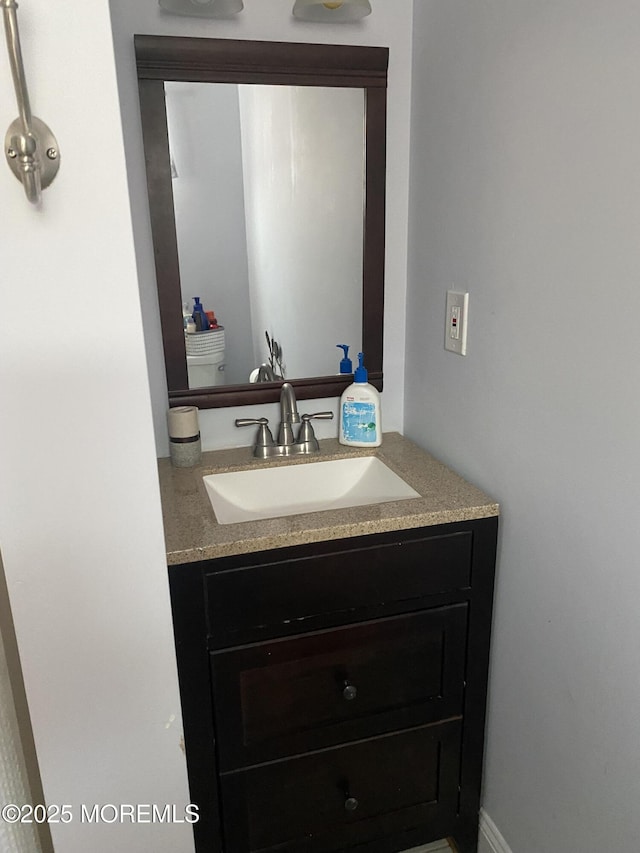 bathroom featuring vanity and toilet