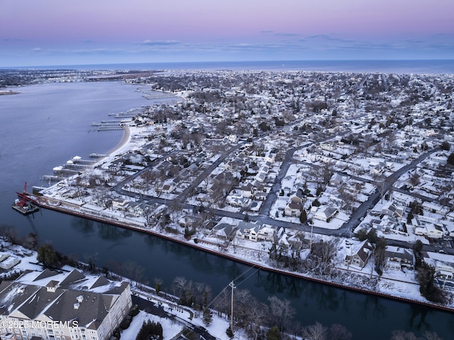 aerial view at dusk with a water view