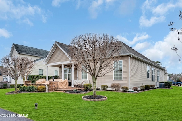 back of house featuring a lawn, central AC unit, and a patio