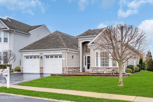 front facade with a front lawn and a garage