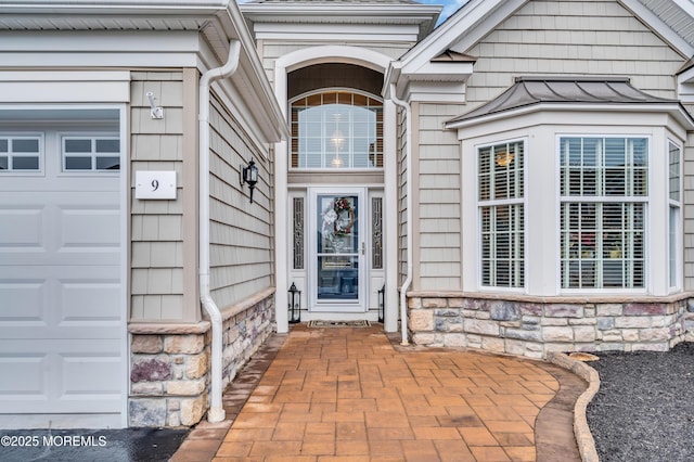 doorway to property featuring a garage