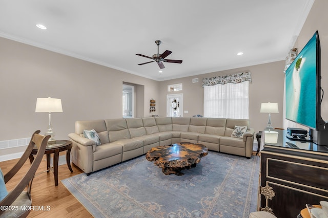 living room with ceiling fan, crown molding, and hardwood / wood-style floors