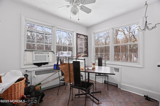 office space with ceiling fan, radiator, dark tile patterned floors, and a textured ceiling