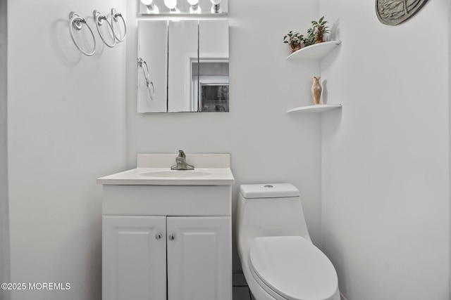 bathroom featuring toilet and vanity