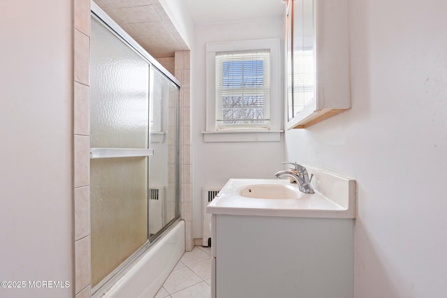 bathroom with vanity, radiator, enclosed tub / shower combo, and tile patterned floors