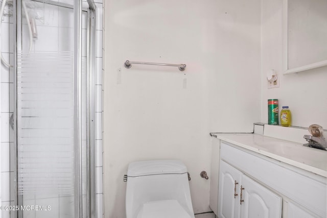 bathroom with toilet, a shower with door, and vanity