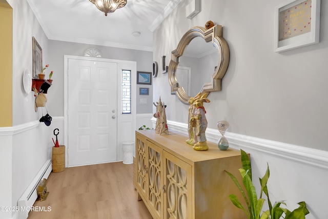 entryway featuring ornamental molding, baseboard heating, and light hardwood / wood-style flooring