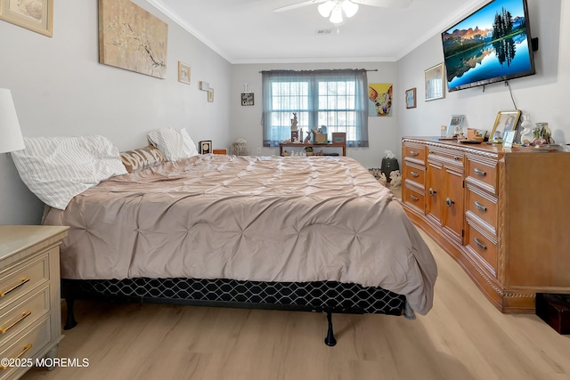 bedroom featuring light hardwood / wood-style flooring, ornamental molding, and ceiling fan