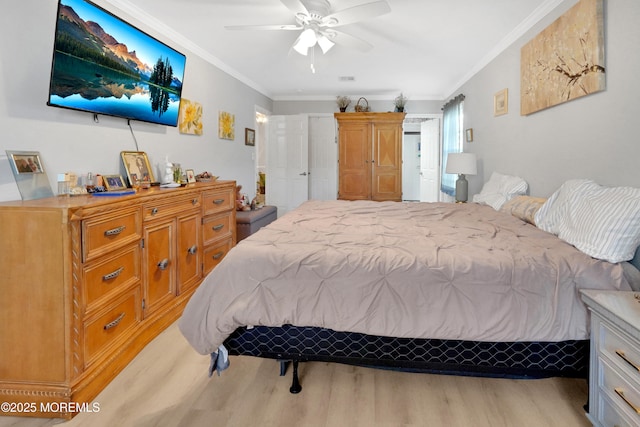 bedroom featuring crown molding, ceiling fan, and light hardwood / wood-style flooring