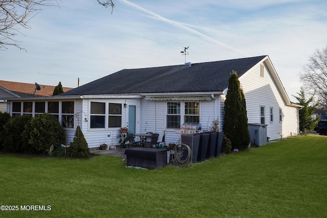 back of property featuring a lawn