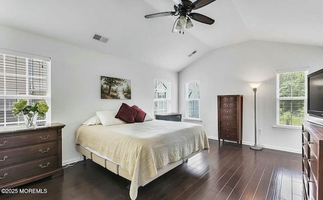 bedroom with ceiling fan, vaulted ceiling, and dark wood-type flooring