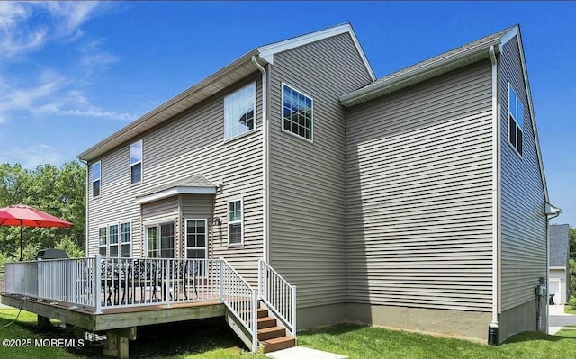 rear view of house featuring a wooden deck