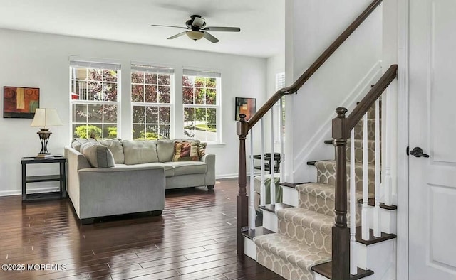 living room featuring ceiling fan and dark wood-type flooring