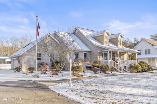 cape cod-style house with a garage and covered porch