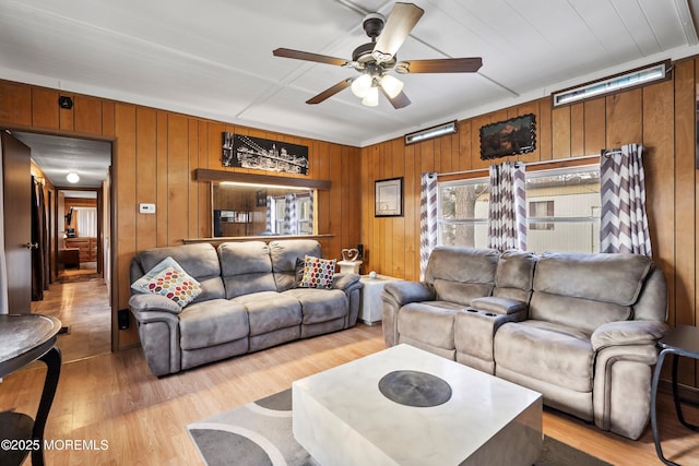 living room with light hardwood / wood-style floors and ceiling fan