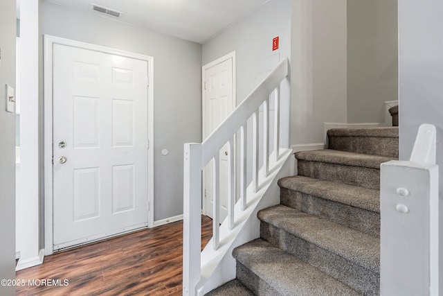 stairway featuring hardwood / wood-style floors