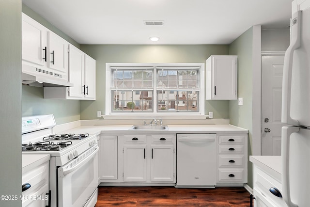 kitchen featuring white cabinetry, sink, white appliances, and dark hardwood / wood-style flooring