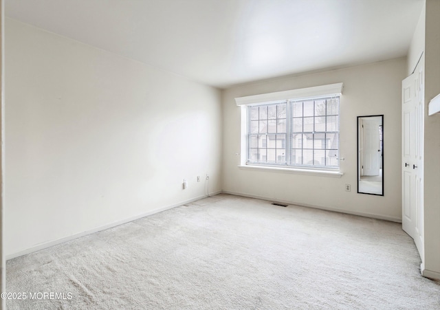 spare room with light carpet