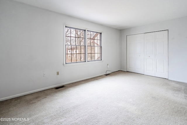 unfurnished bedroom featuring a closet and carpet flooring