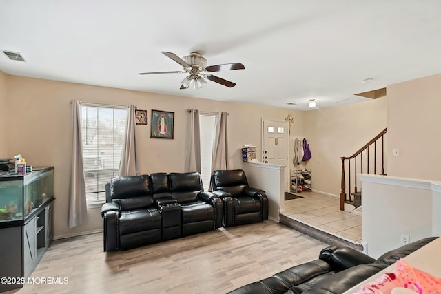 living room with ceiling fan and light hardwood / wood-style flooring