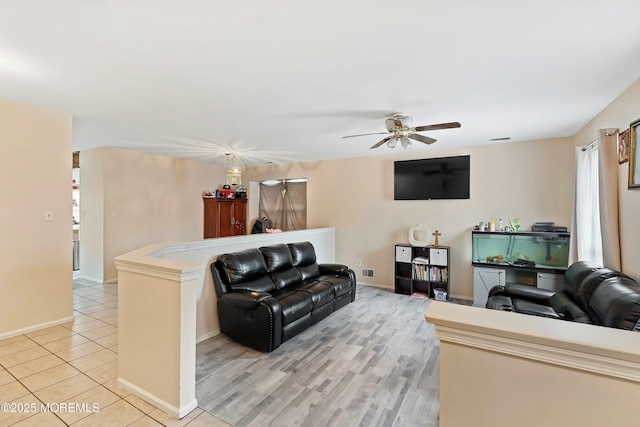 tiled living room with ceiling fan